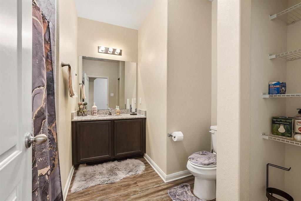 3005 Parker Road Anna, TX 75409 - Photo 16 of 33 Bathroom featuring vanity, light wood finished floors, and curtained shower