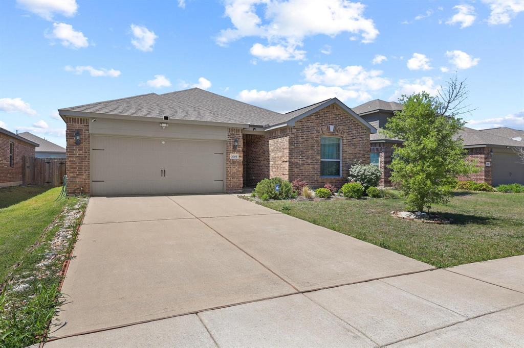 3005 Parker Road Anna, TX 75409 - Photo 2 of 33 Ranch-style house with brick siding, an attached garage, concrete driveway, and a shingled roof