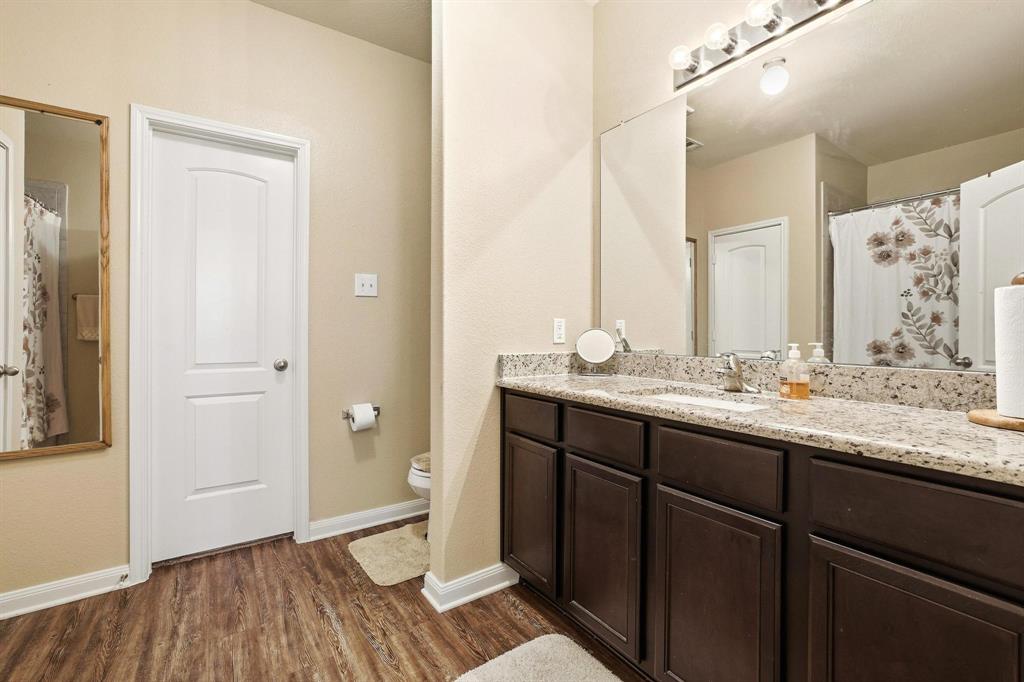 3005 Parker Road Anna, TX 75409 - Photo 25 of 33 Bathroom with curtained shower, vanity, and dark wood-style flooring