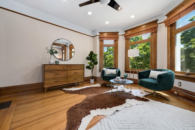 a bedroom with furniture and a large window