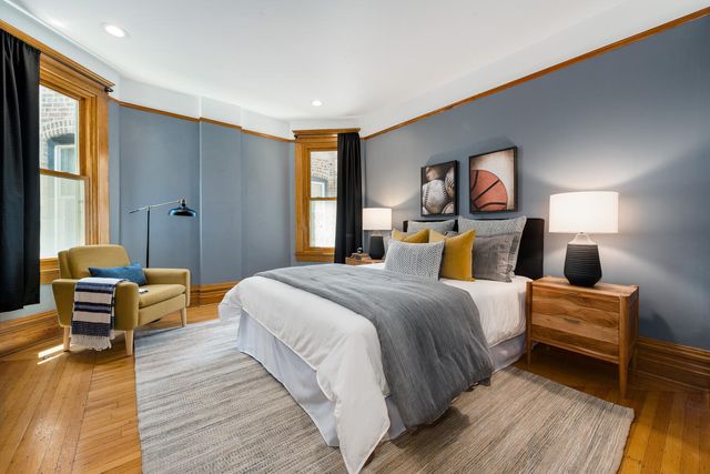 a bedroom with bed and wooden floor