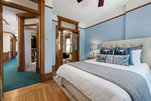 a bedroom with a bed and a mirror