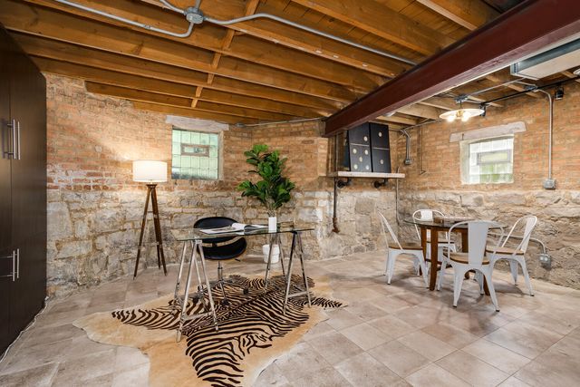 a view of a patio with table and chairs and potted plants