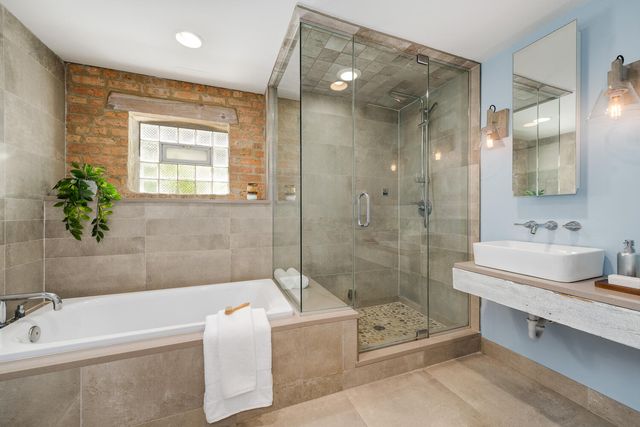 a bathroom with a tub sink and mirror