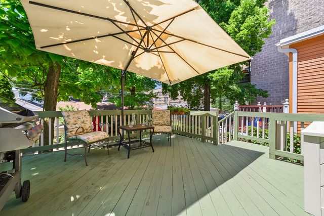 a view of a deck with chairs and wooden floor