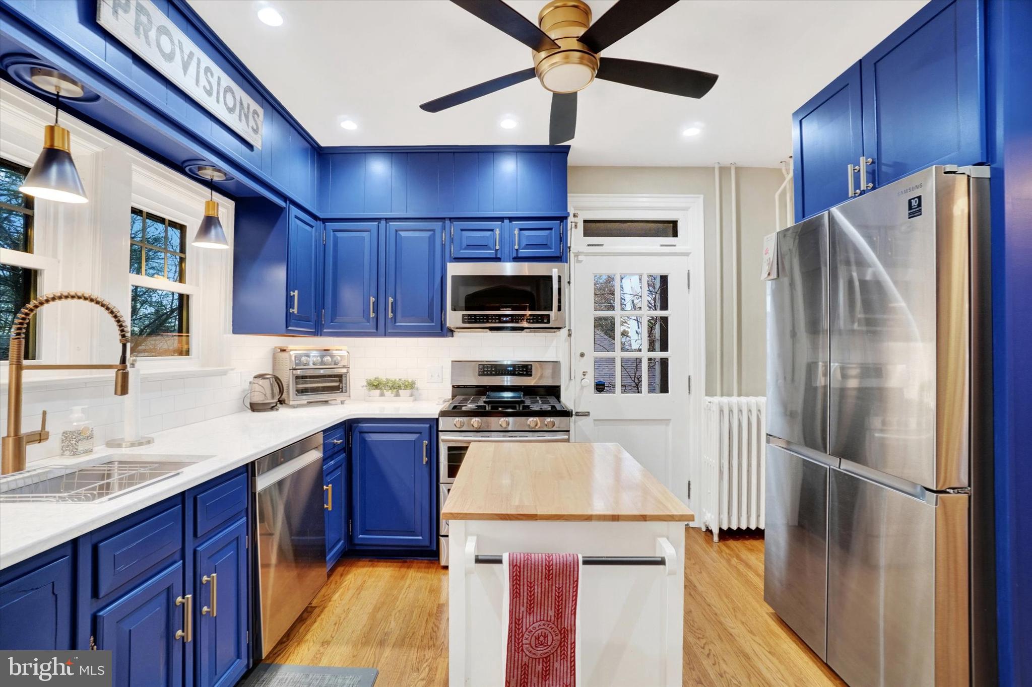 185 Peyton Road York, PA 17403 - Photo 17 of 38 a kitchen with stainless steel appliances granite countertop a refrigerator a stove and a sink with wooden floors
