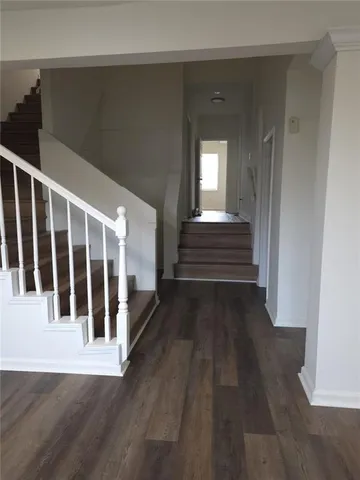 a view of a porch with wooden floor and fence