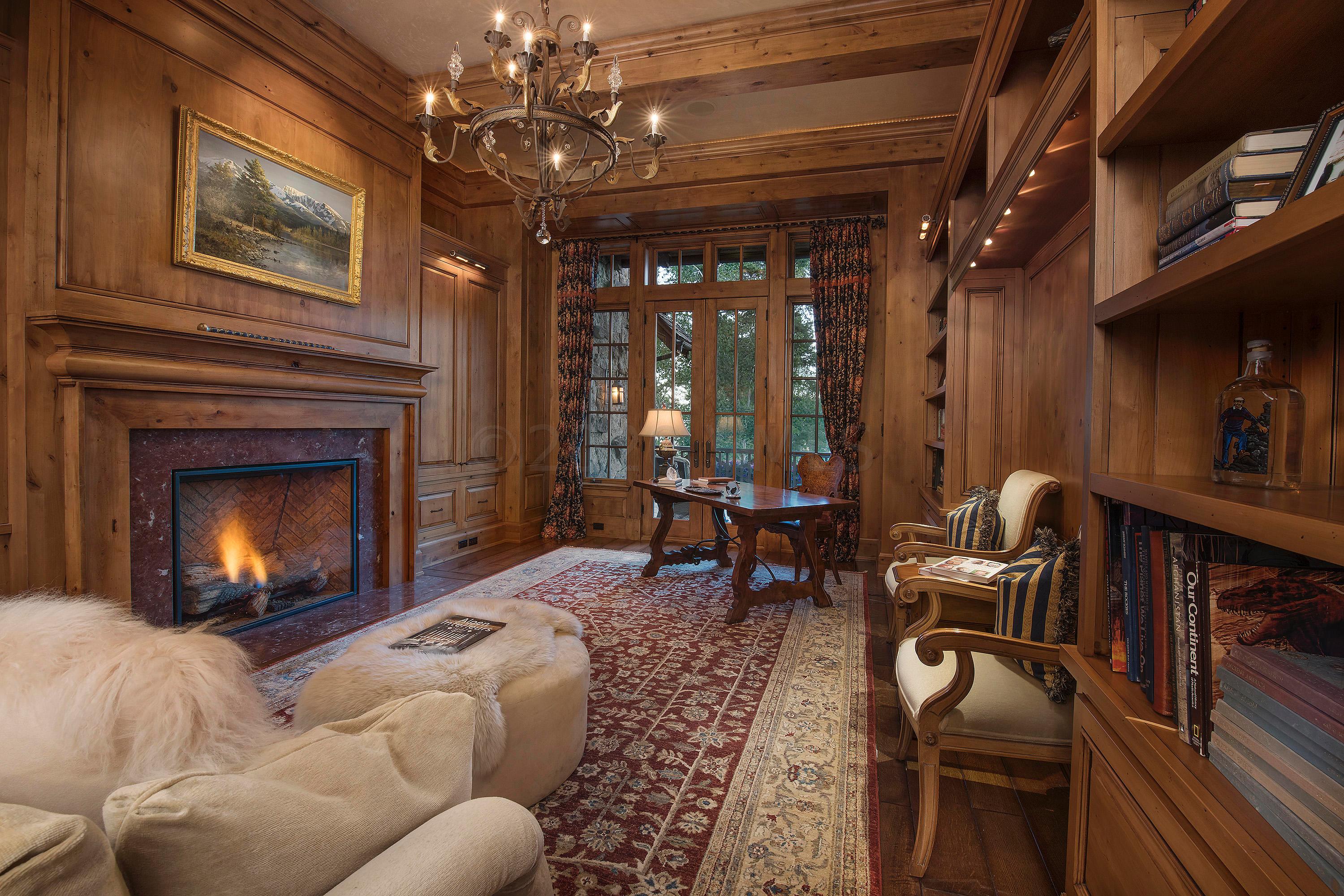 3882 Daybreak Ridge Road Avon, CO 81620 - Photo 15 of 33 a living room with furniture a chandelier and a fireplace