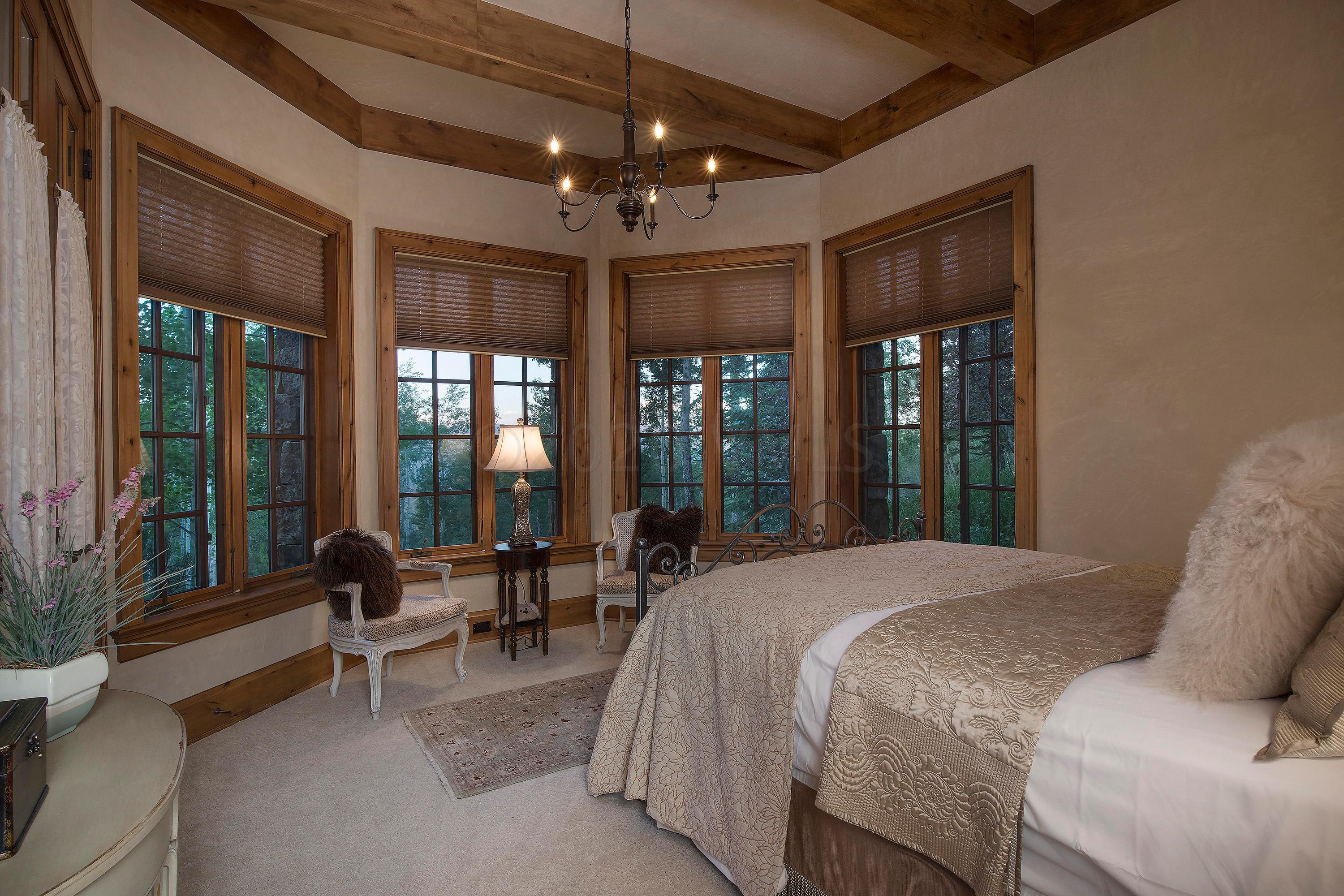 3882 Daybreak Ridge Road Avon, CO 81620 - Photo 21 of 33 a spacious bedroom with a bed and a large window