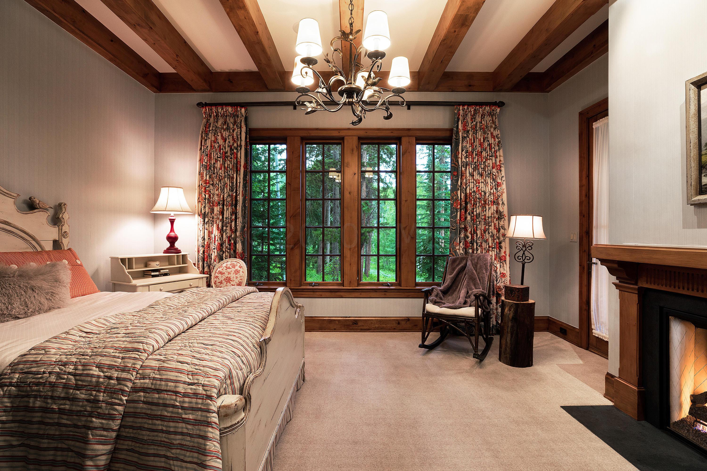 3882 Daybreak Ridge Road Avon, CO 81620 - Photo 23 of 33 a bedroom with a bed and a chandelier