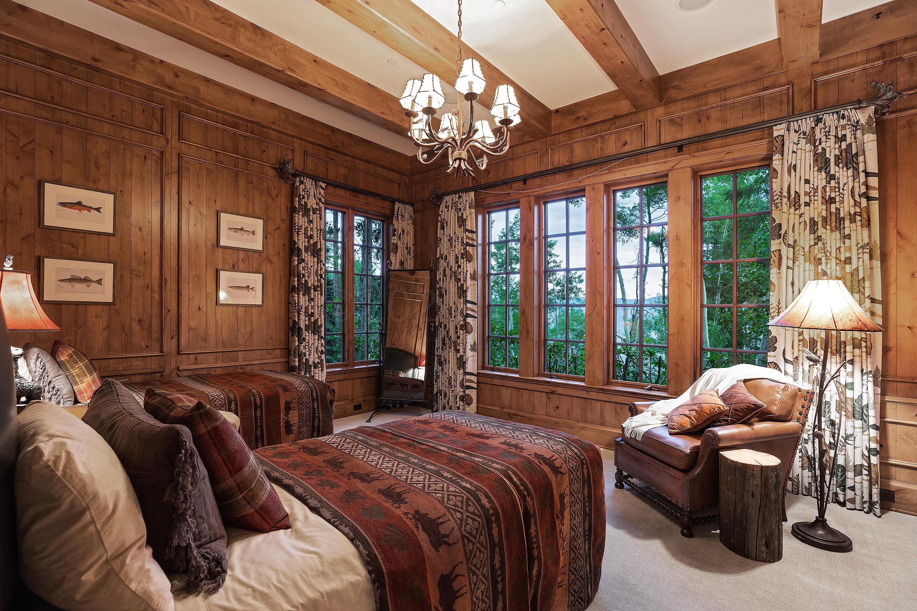 3882 Daybreak Ridge Road Avon, CO 81620 - Photo 24 of 33 a spacious bedroom with two beds and a large window