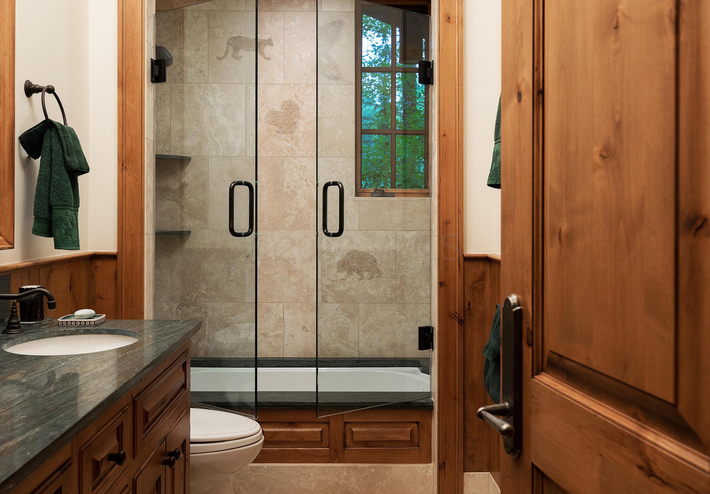 3882 Daybreak Ridge Road Avon, CO 81620 - Photo 28 of 33 a bathroom with a granite countertop sink a toilet and shower
