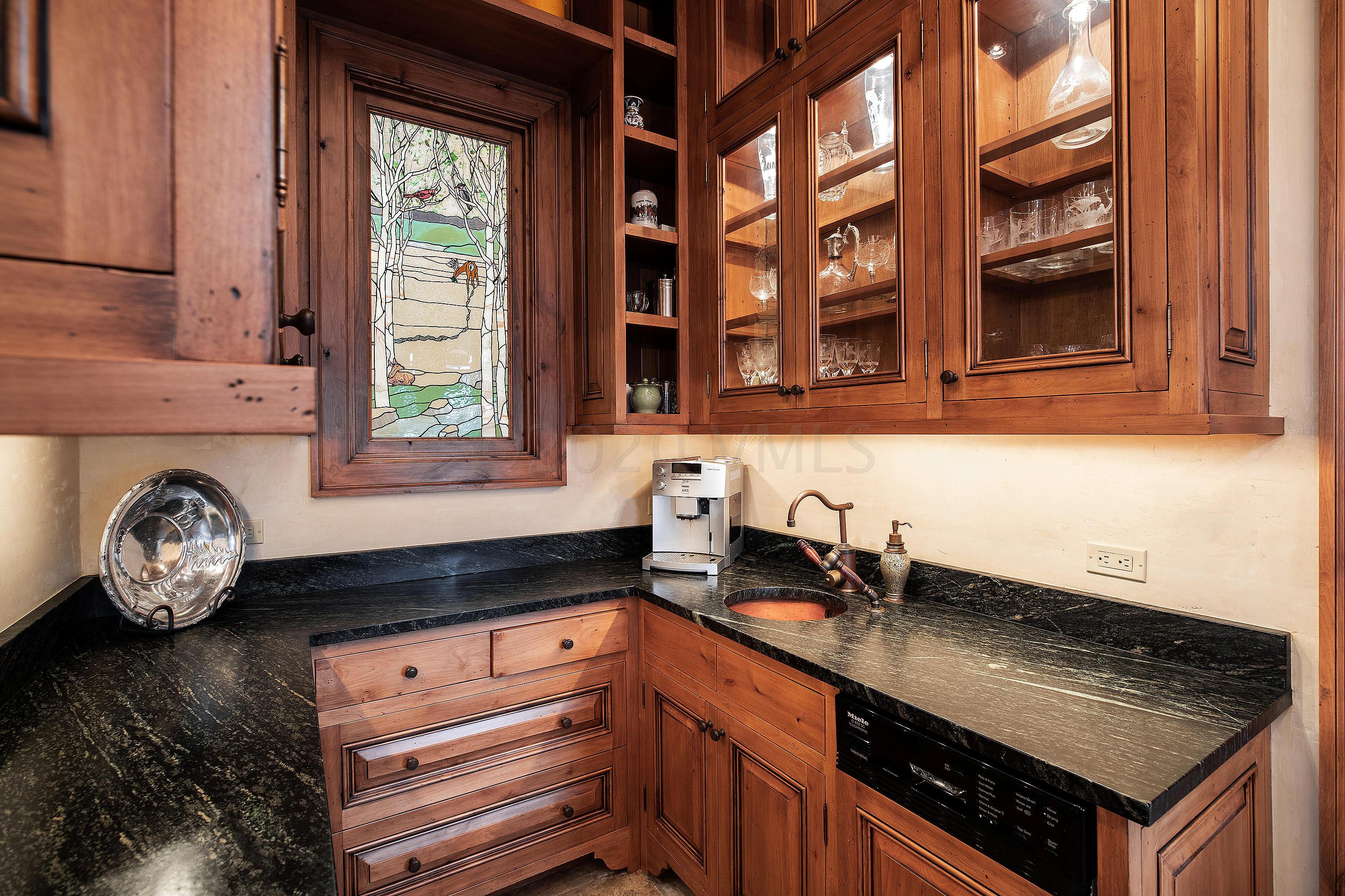 3882 Daybreak Ridge Road Avon, CO 81620 - Photo 30 of 33 a kitchen with granite countertop a sink a stove and cabinets