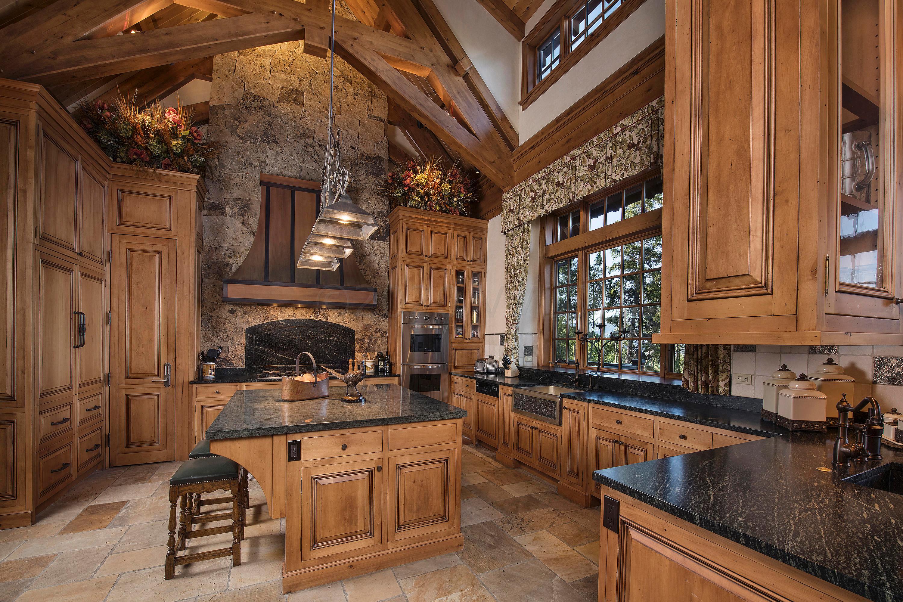 3882 Daybreak Ridge Road Avon, CO 81620 - Photo 3 of 33 a kitchen with stainless steel appliances granite countertop a sink a stove and cabinets