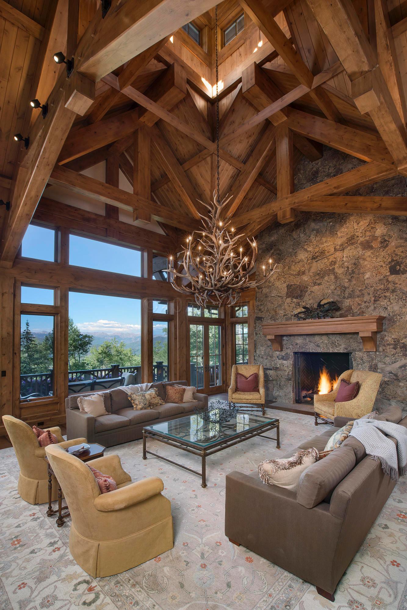 3882 Daybreak Ridge Road Avon, CO 81620 - Photo 5 of 33 a living room with furniture and a fireplace