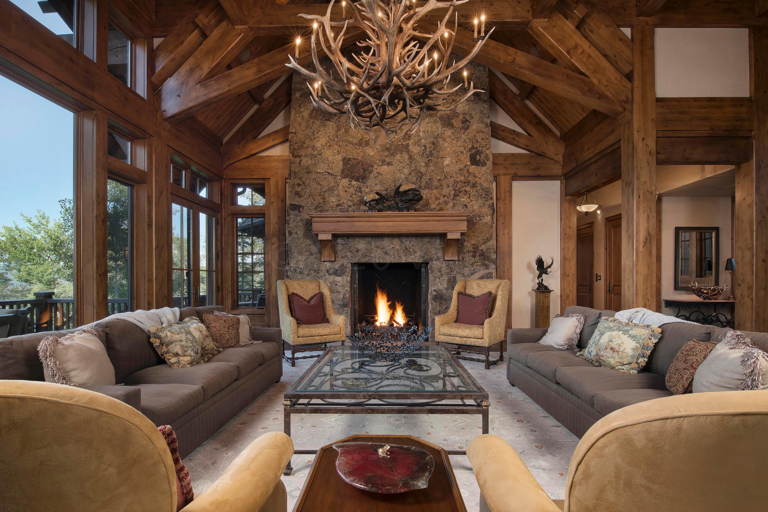 3882 Daybreak Ridge Road Avon, CO 81620 - Photo 7 of 33 a living room with furniture and a fireplace