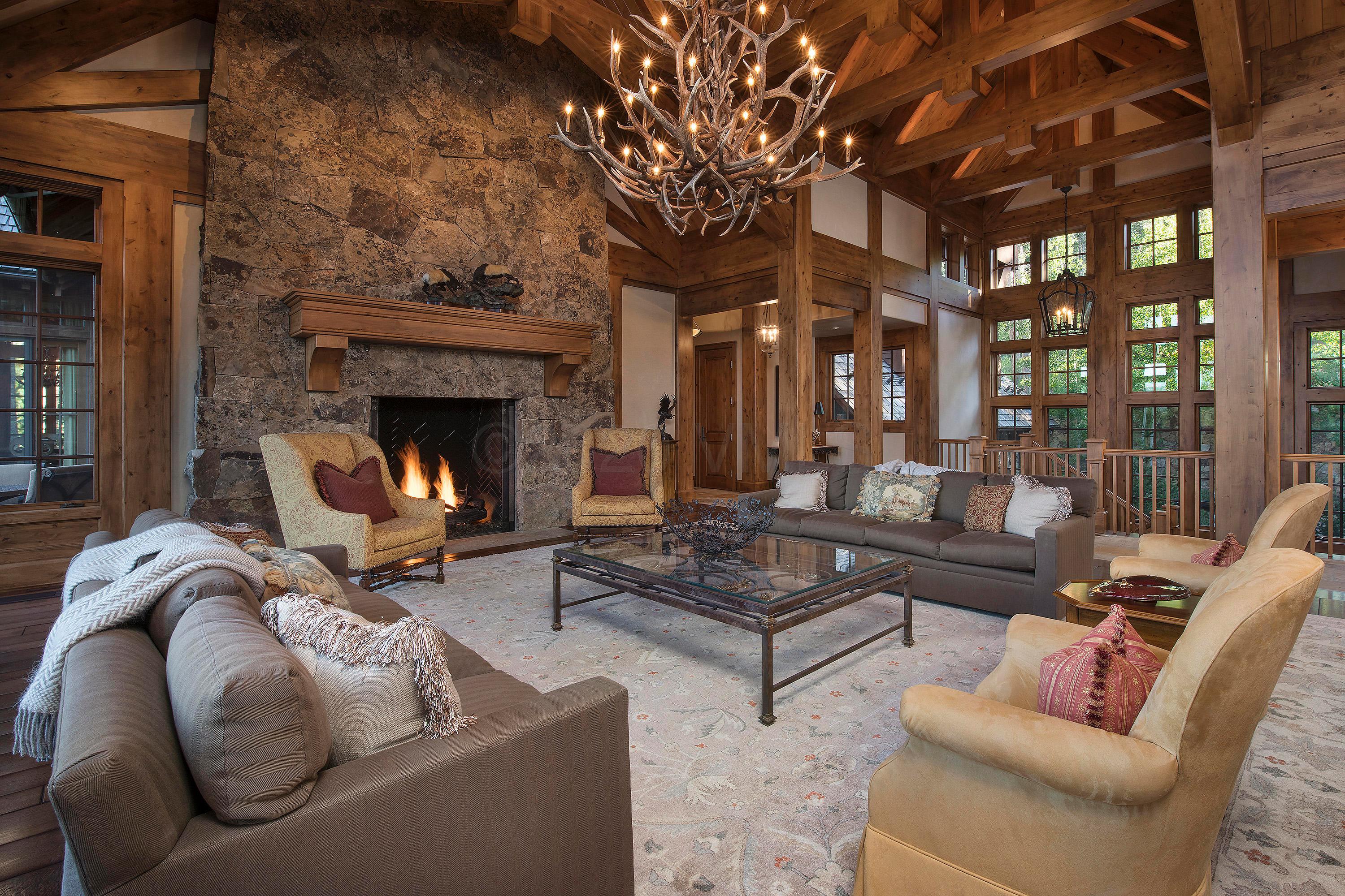 3882 Daybreak Ridge Road Avon, CO 81620 - Photo 8 of 33 a living room with furniture and a fireplace