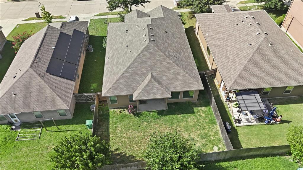 720 Rio Bravo Drive Fort Worth, TX 76052 - Photo 36 of 38 Spacious backyard featuring a covered patio, a privacy fence, and a large grassy area