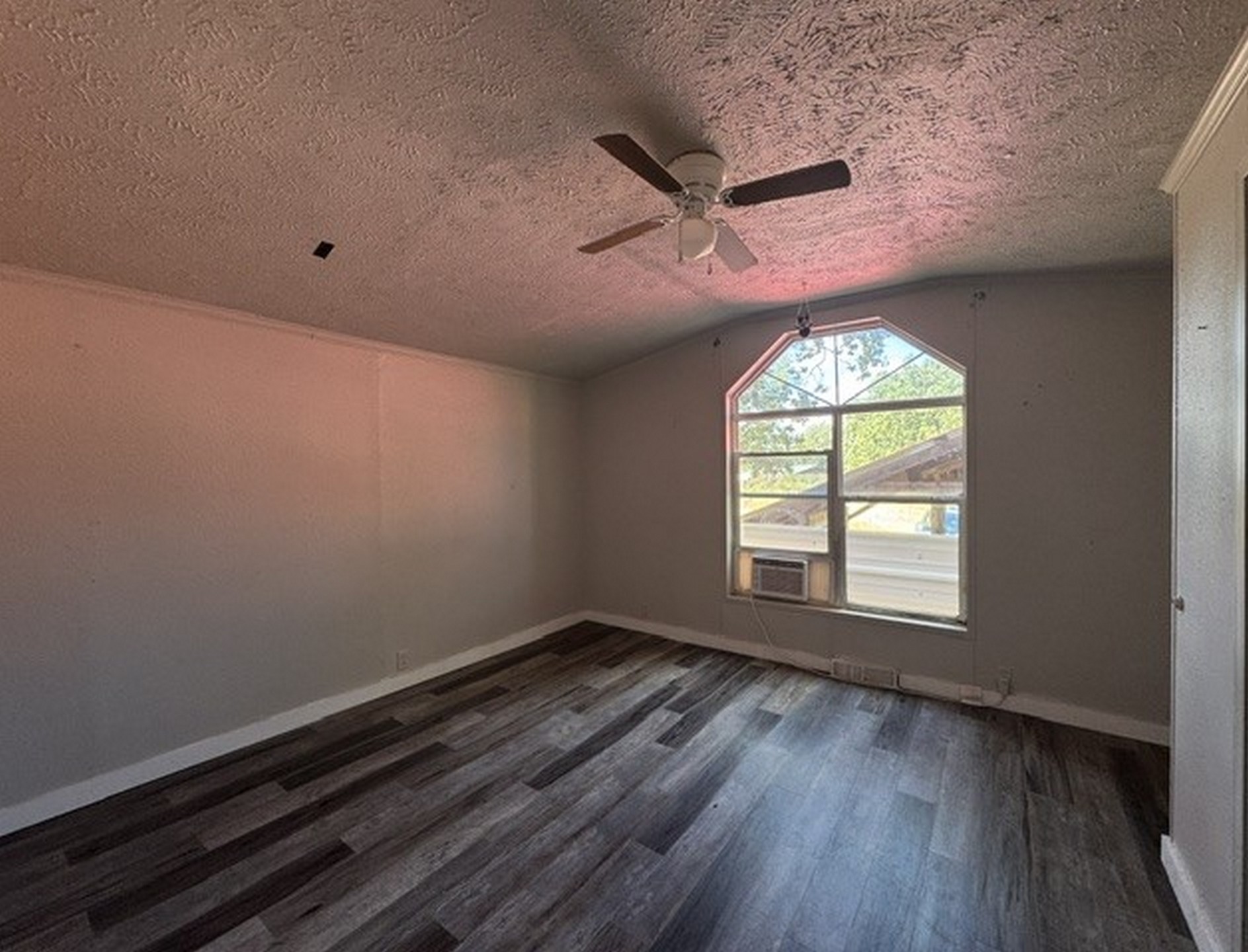 109558 South 4760 Road Muldrow, OK 74948 - Photo 22 of 22 Wood-finish flooring, ceiling fan, and arched window with multiple panes
