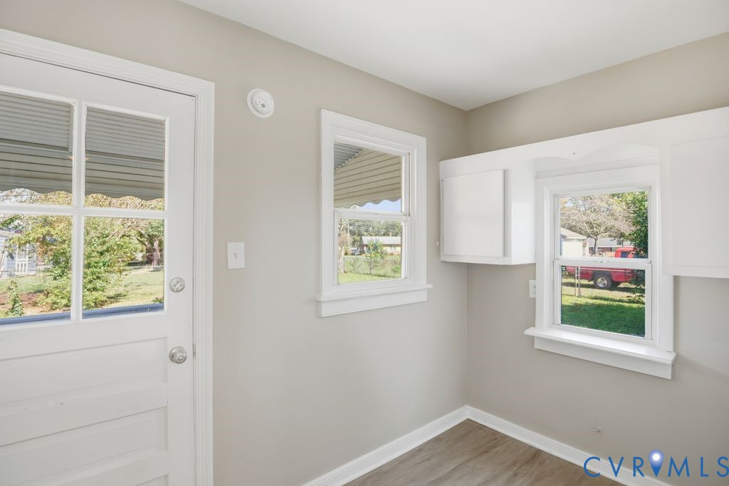 4216 Sheffield Road Richmond, VA 23224 - Photo 11 of 23 a view of an empty room with a window and a kitchen