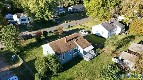 an aerial view of a house with a garden and swimming pool