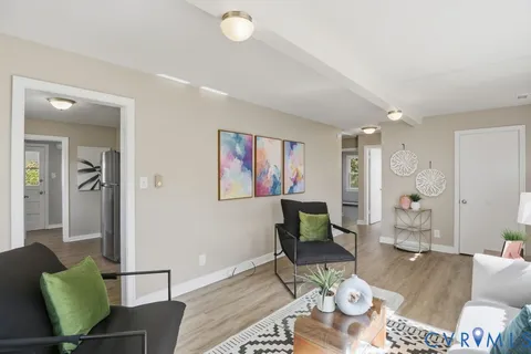 a living room with furniture and wooden floor