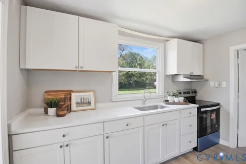 a kitchen with a sink cabinets and window