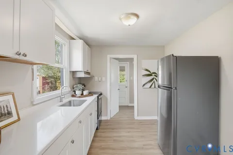 a kitchen with a refrigerator a sink and a window