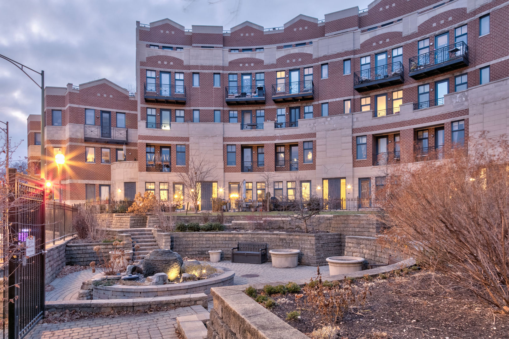 7746 North Sheridan Road, Unit 2L Chicago, IL 60626 - Photo 2 of 22 a front view of a building with street yard and fountain