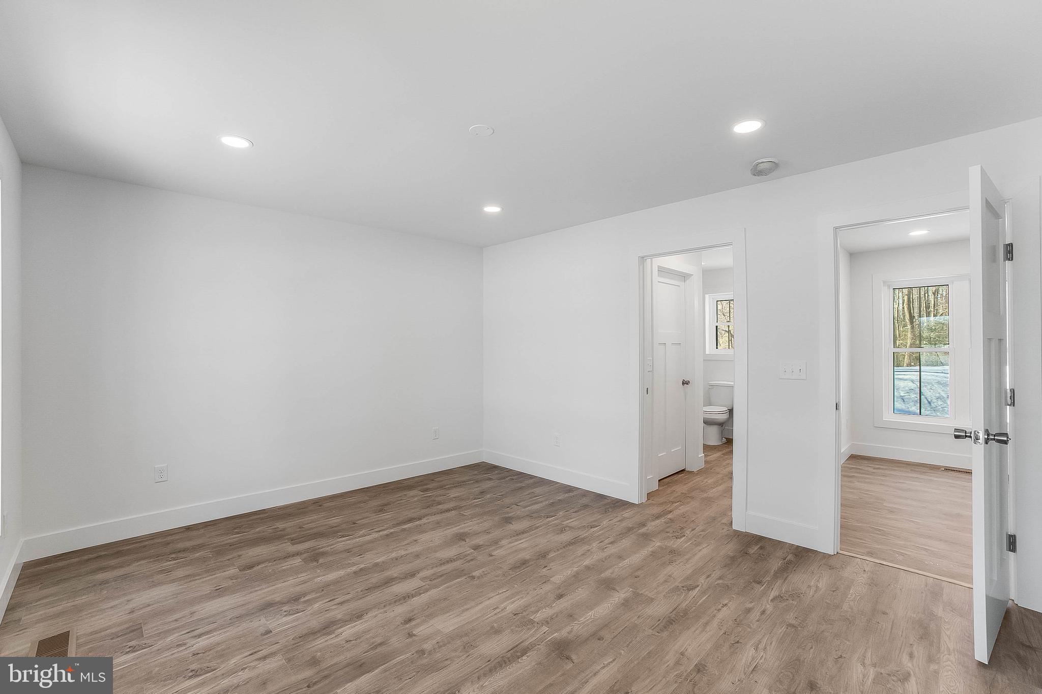 1255 Rose Valley School Road Dover, DE 19904 - Photo 11 of 26 wooden floor in an empty room with a window