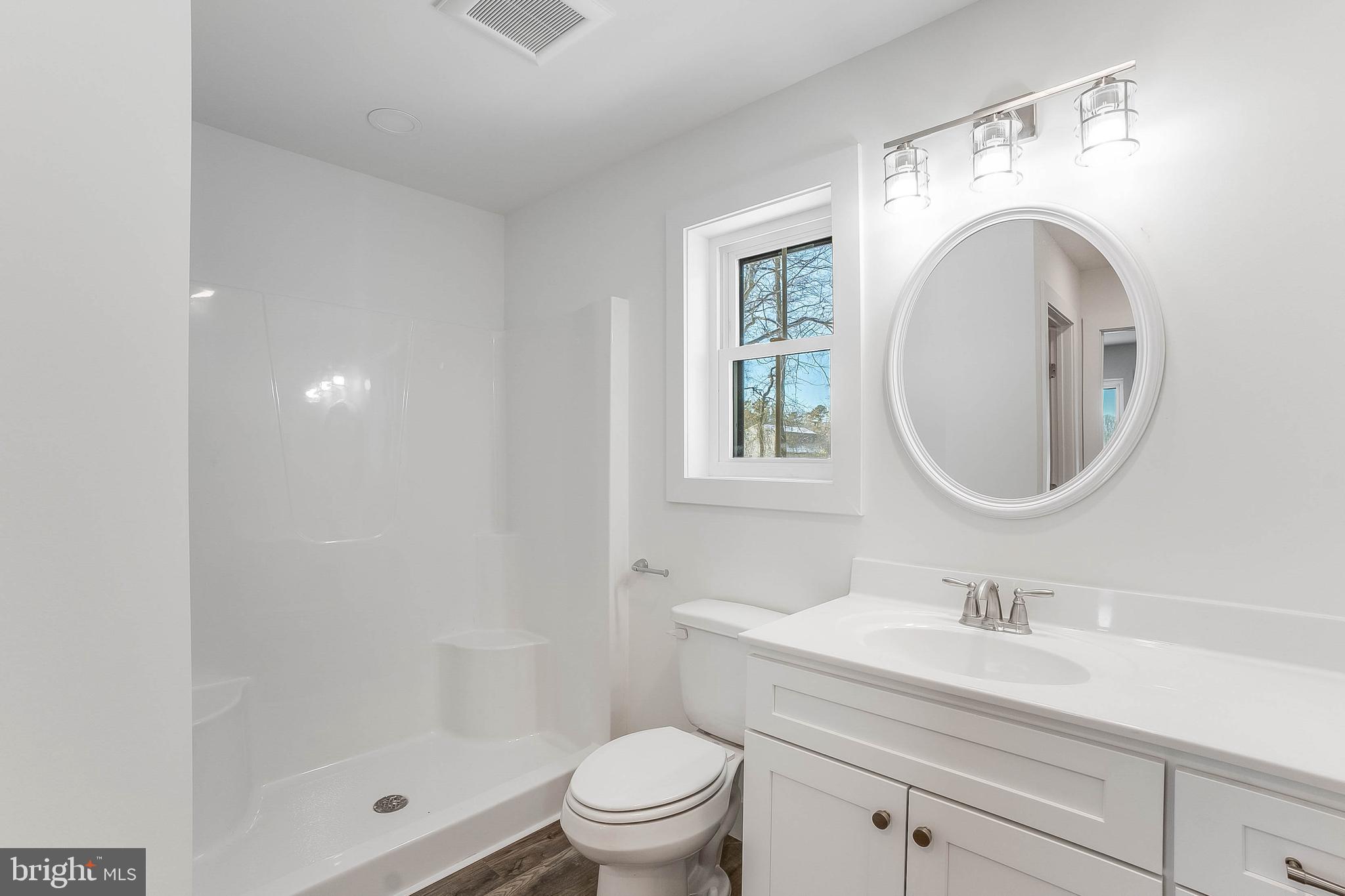 1255 Rose Valley School Road Dover, DE 19904 - Photo 15 of 26 a bathroom with a toilet a sink a mirror and a shower