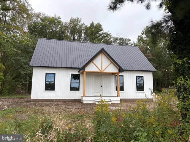 a house that has a tree in front of it