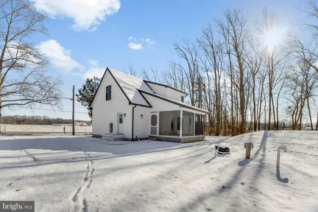 a view of a house with snow on the road