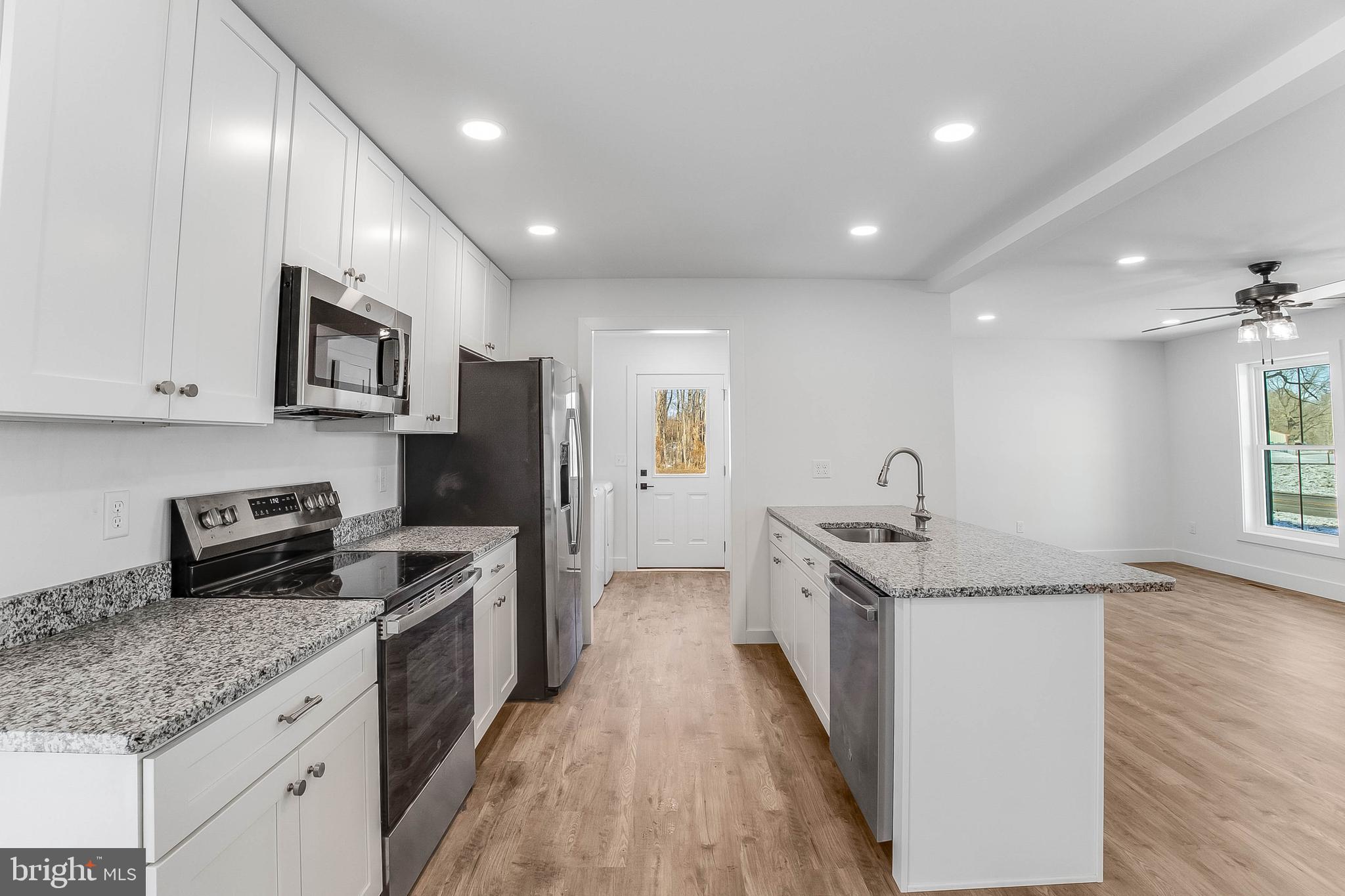 1255 Rose Valley School Road Dover, DE 19904 - Photo 7 of 26 a kitchen with stainless steel appliances granite countertop a sink stove and refrigerator