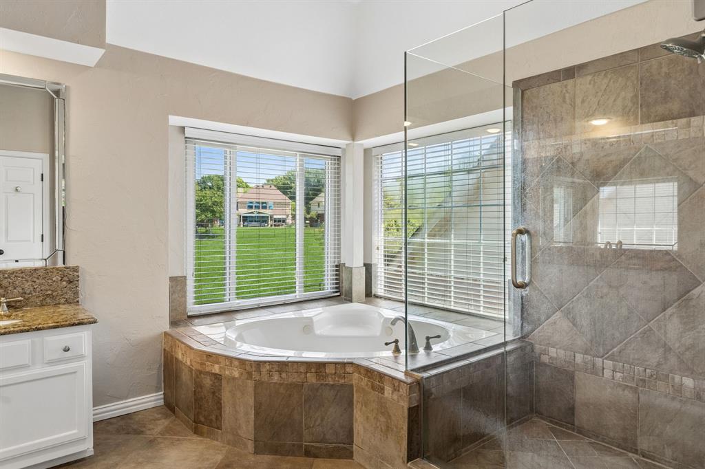 2925 Sunset Ridge McKinney, TX 75072 - Photo 29 of 33 Another view of the stunning spa-style primary bath offering a large soaking tub, oversized glass shower, elegant tile details, and panoramic golf course views that elevate everyday living.