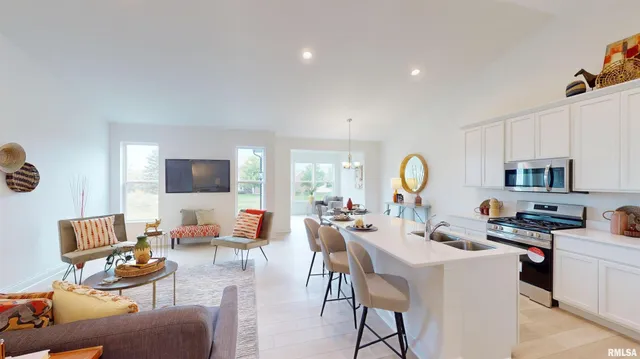 a living room with furniture a flat screen tv and a window