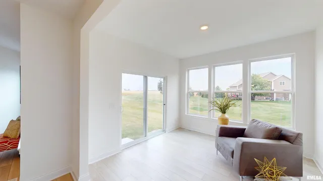 a living room with furniture and a large window with outer view