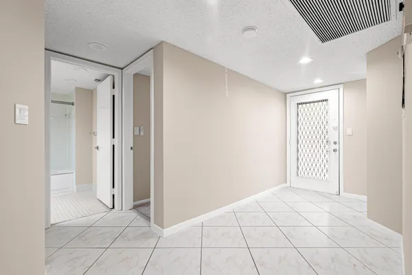 an empty room with a empty space and windows