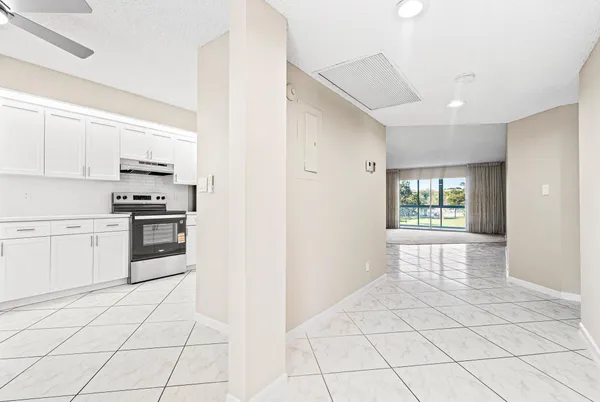 a kitchen with stainless steel appliances a refrigerator sink and cabinets