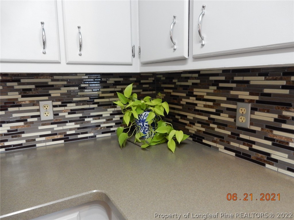 1001 Anarine Road Fayetteville, NC 28303 - Photo 11 of 24 a close view of a stove a cabinets and a window