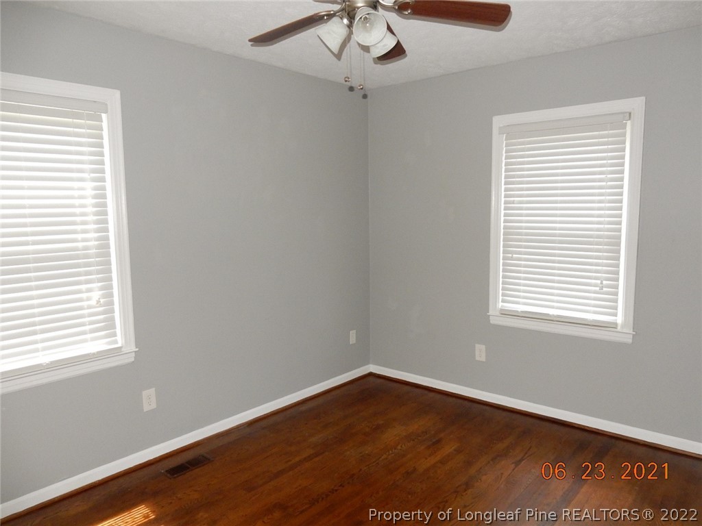1001 Anarine Road Fayetteville, NC 28303 - Photo 17 of 24 a view of an empty room with wooden floor and a window