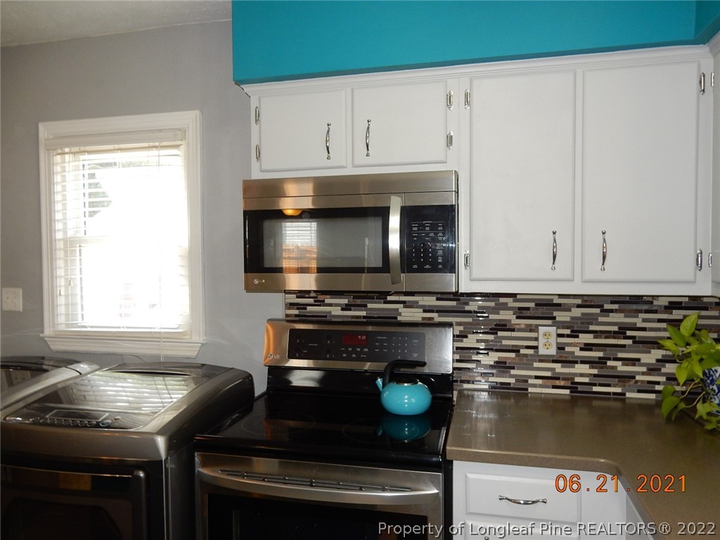 1001 Anarine Road Fayetteville, NC 28303 - Photo 10 of 24 a kitchen with a stove and a microwave