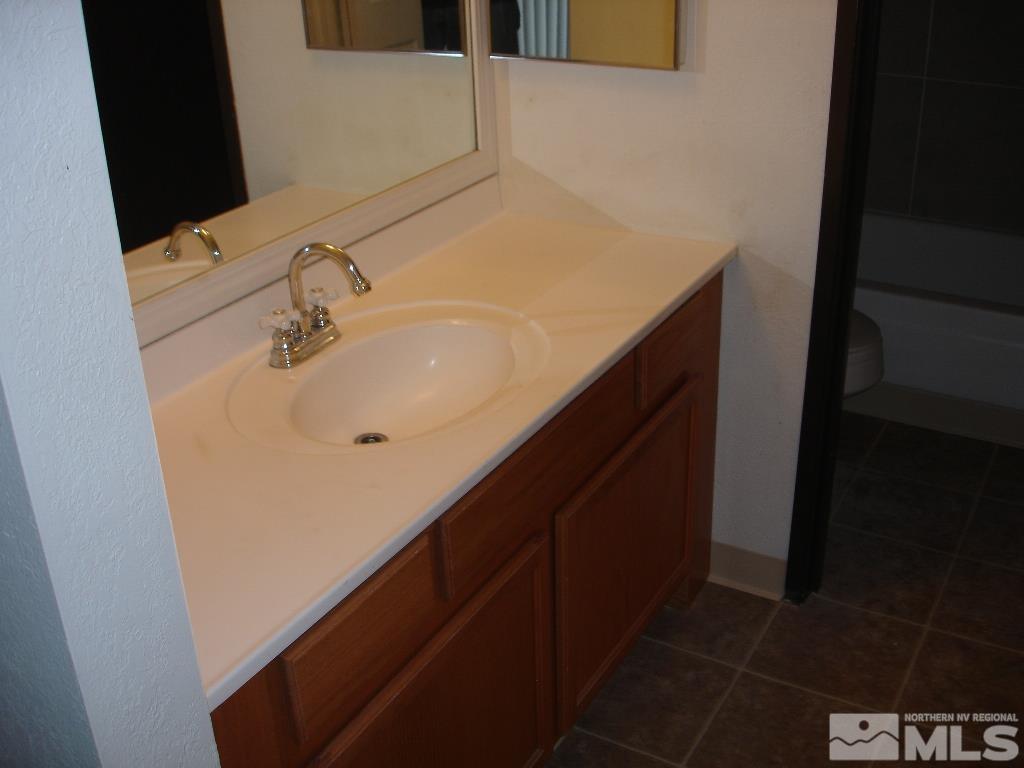 2450 Lymbery Street, Unit 309 Reno, NV 89509 - Photo 6 of 10 a bathroom with a sink and a mirror