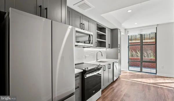 a kitchen with stainless steel appliances a refrigerator sink and cabinets