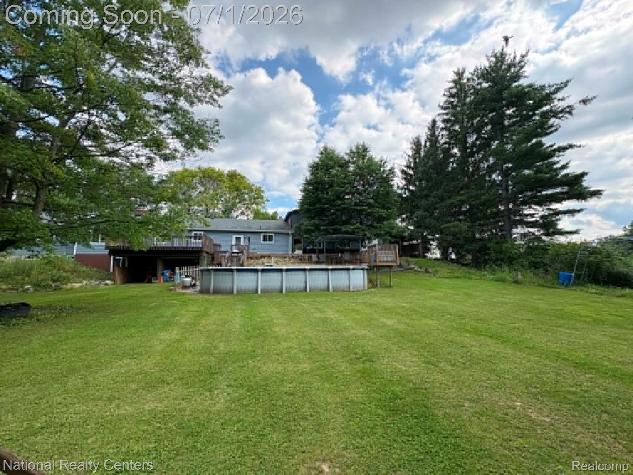 1330 Brauer Road Oxford, MI 48371 - Photo 8 of 54 Expansive green lawn featuring an above-ground pool