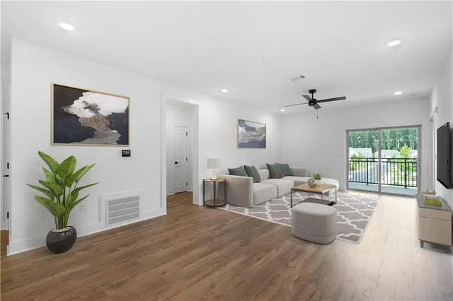 a living room with furniture a large window with wooden floor