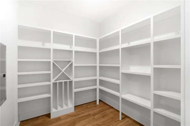 a view of walk in closet with empty racks