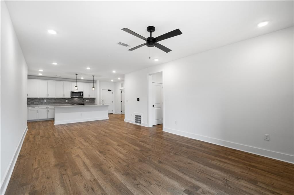 3321 Orwell Way, Unit 3301 Cumming, GA 30041 - Photo 16 of 43 a view of kitchen with wooden floor and window