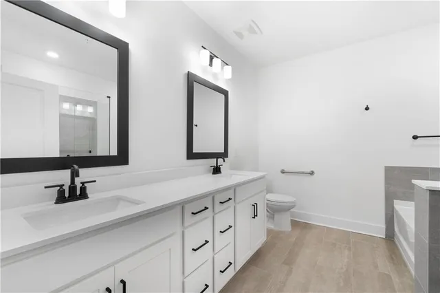 a bathroom with double vanity sinks and a mirror