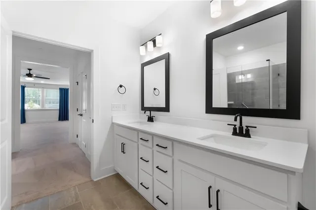 a bathroom with double vanity sinks and a mirror